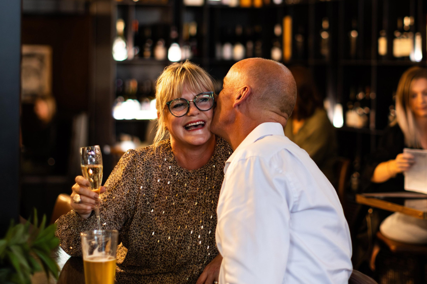 Vine-restaurant-bar-older-couple-kissing-wine-celebrating-lady-happy-welcome-846x564